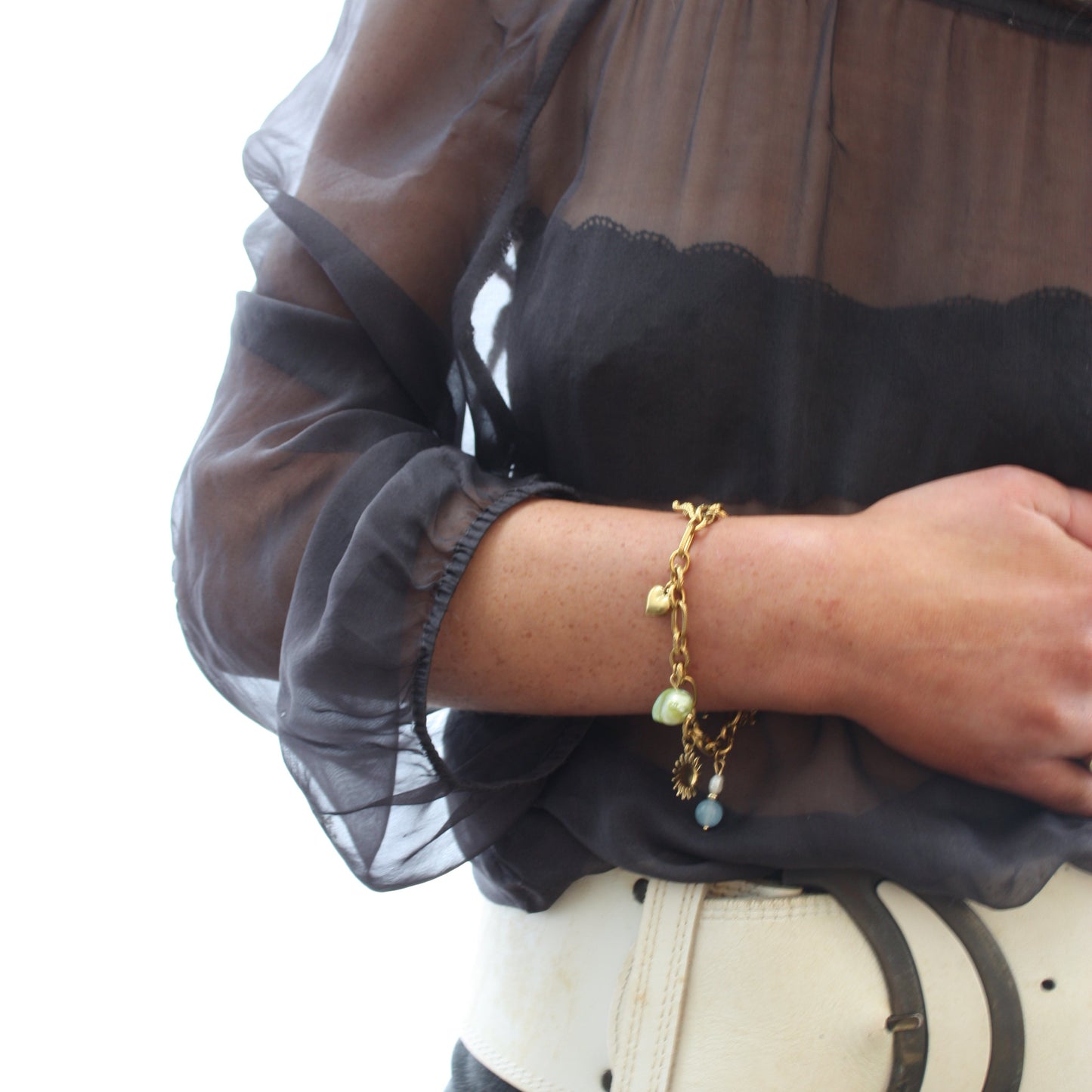 A fashionable Custom Charm Bracelet showcased on a wrist, adorned with colourful charms and shining beads, perfect for stylish individuality.