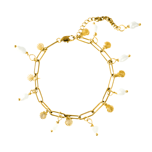 Elegantly designed pearl charm bracelet featuring seashells and freshwater pearls, showcasing a delicate and ocean-inspired aesthetic.