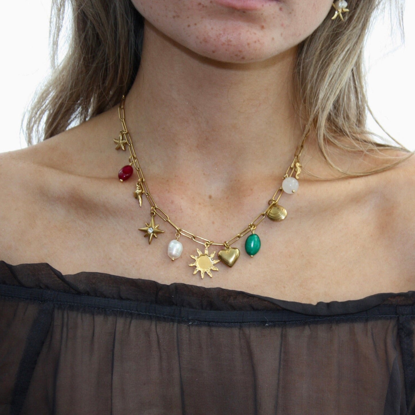 Fashionable Custom Charm Necklace featuring a combination of different charms, including stars and hearts, worn by a model.