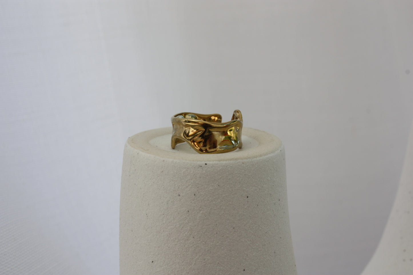 A detailed view of the Aurora Ring by ÈRE, showcasing the intricate hammered finish and asymmetrical style, making it a standout asymmetrical gold ring accessory.